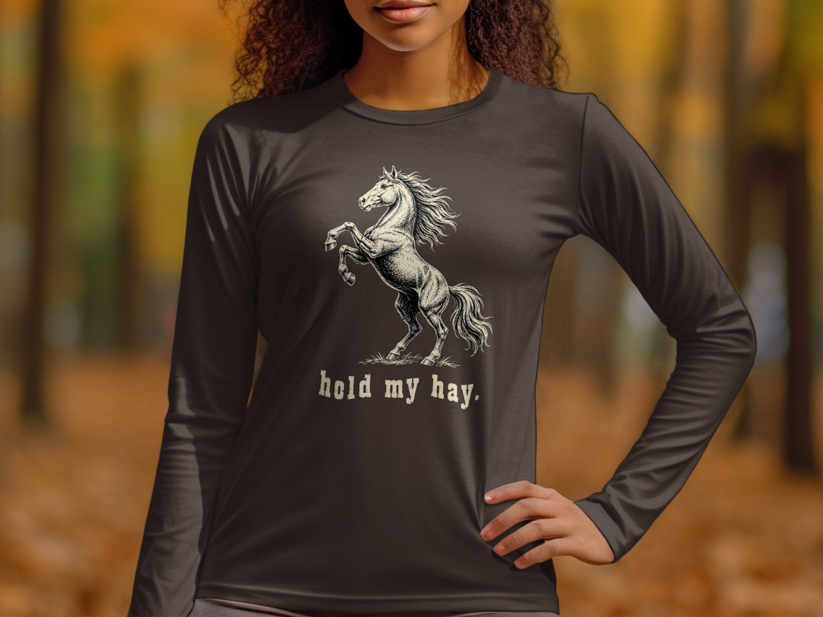 Dark long-sleeve t-shirt with a rearing horse graphic and "hold my hay." text.