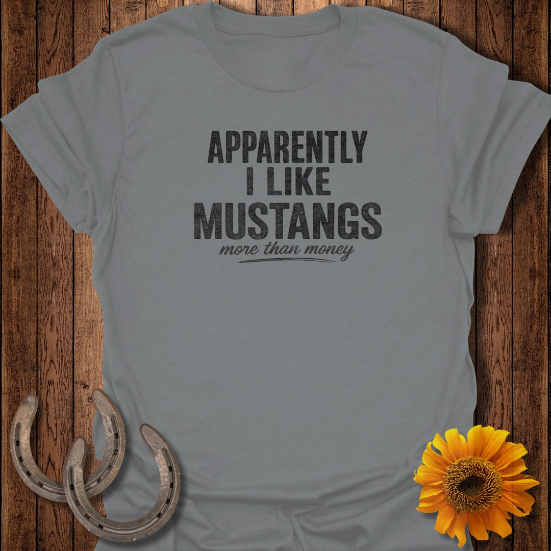 Grey t-shirt with "Apparently I Like Mustangs More Than Money" text and decorative horseshoes and sunflower.