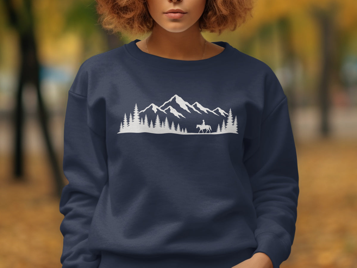 Navy blue sweatshirt with a white mountain and forest graphic featuring a person on horseback.