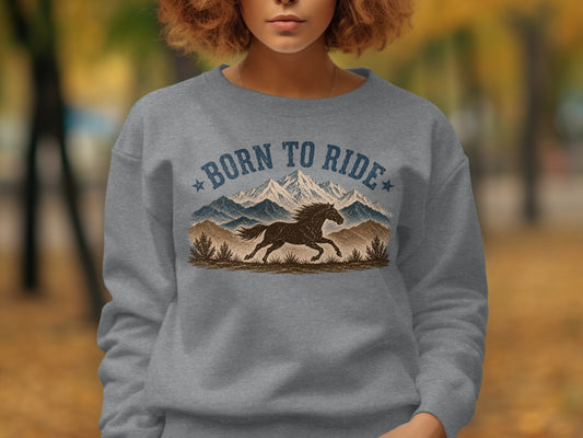 Gray sweatshirt with "Born to Ride" text above a running horse and mountains.