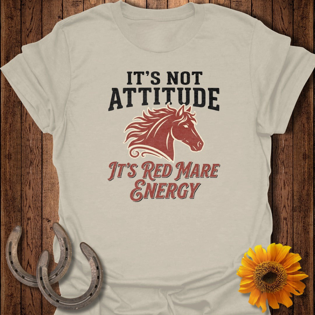 Tan t-shirt with "It's Not Attitude, It's Red Mare Energy" and horse graphic.