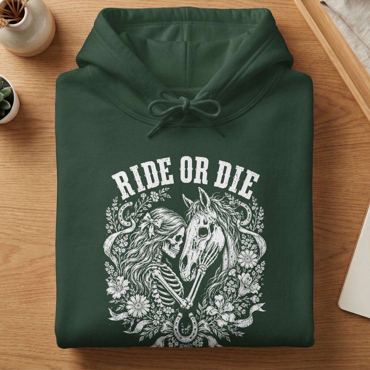 Dark green hoodie with a white skeleton, horse, and floral graphic and text.