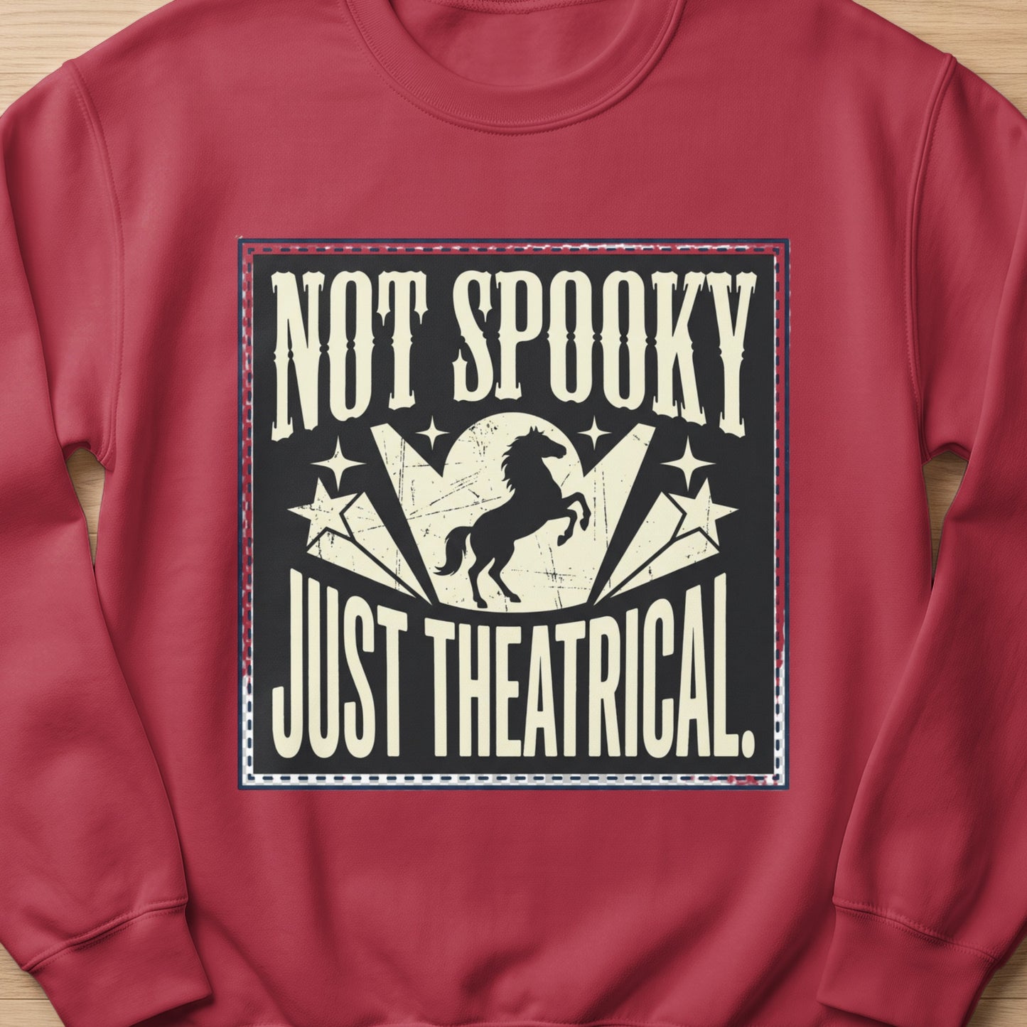Crew neck sweatshirt with "Not Spooky Just Theatrical" text and a horse graphic.