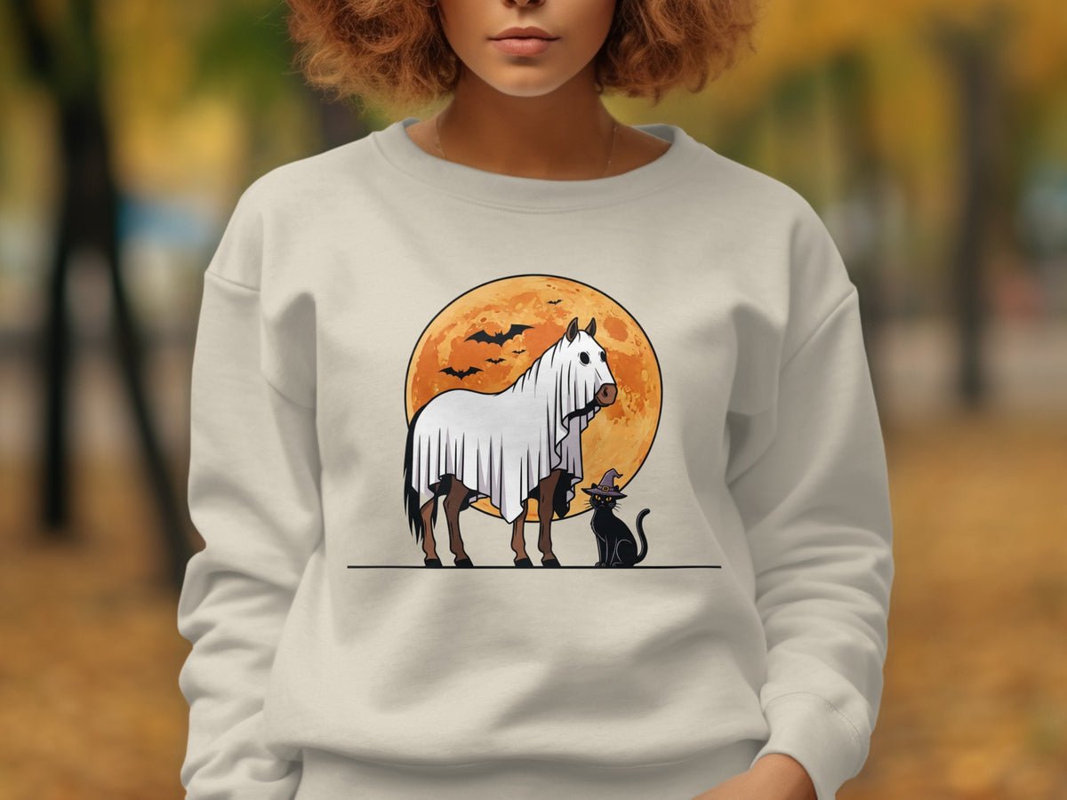 Horse in ghost costume with black cat and bats against orange moon.