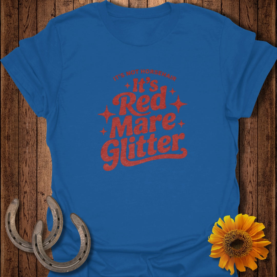 Royal blue t-shirt with red text that reads "It's Not Horsehair, It's Red Mare Glitter."