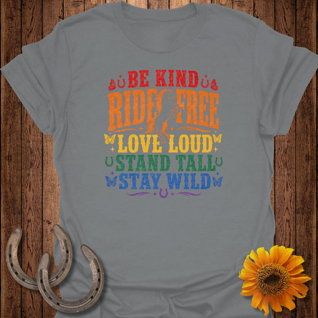 Gray t-shirt with colorful "Be Kind Ride Free Love Loud Stand Tall Stay Wild" text.