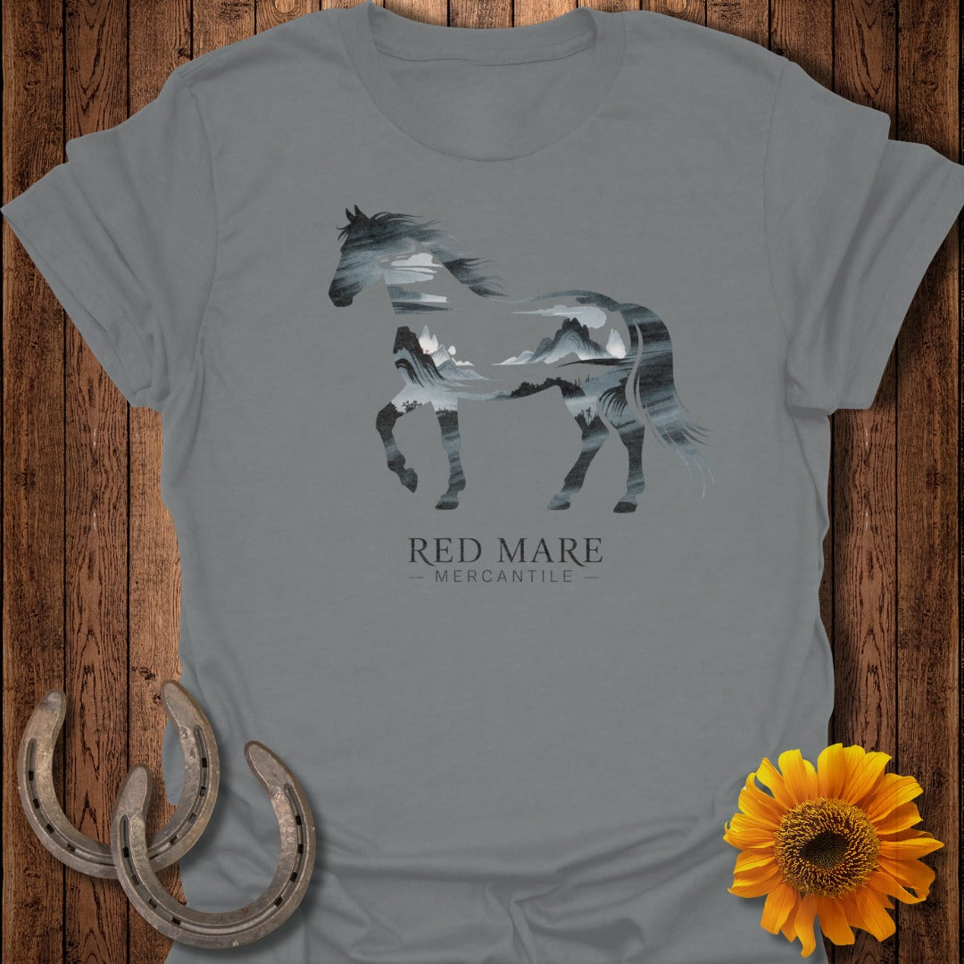 Gray t-shirt with a horse silhouette filled with mountains and clouds.