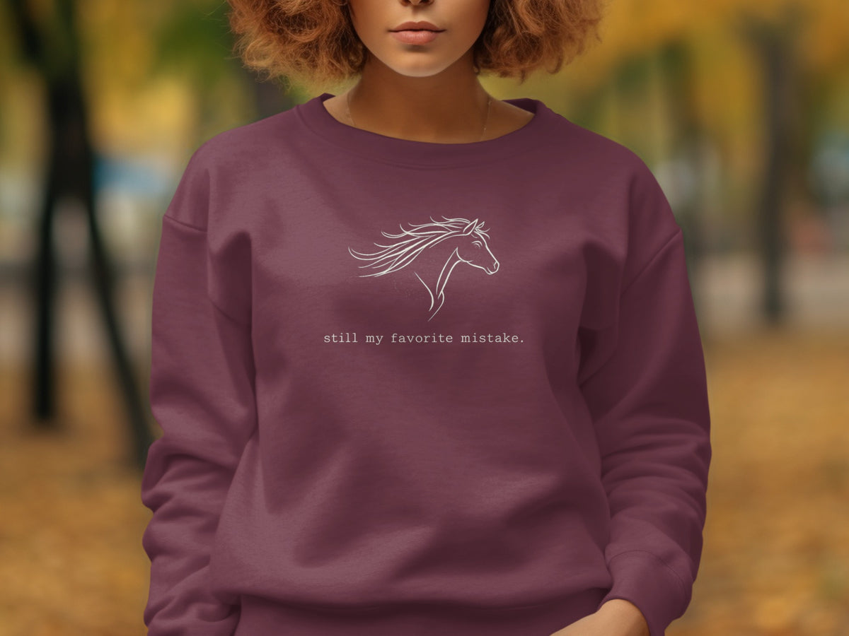 Burgundy sweatshirt with white horse outline and text "still my favorite mistake."