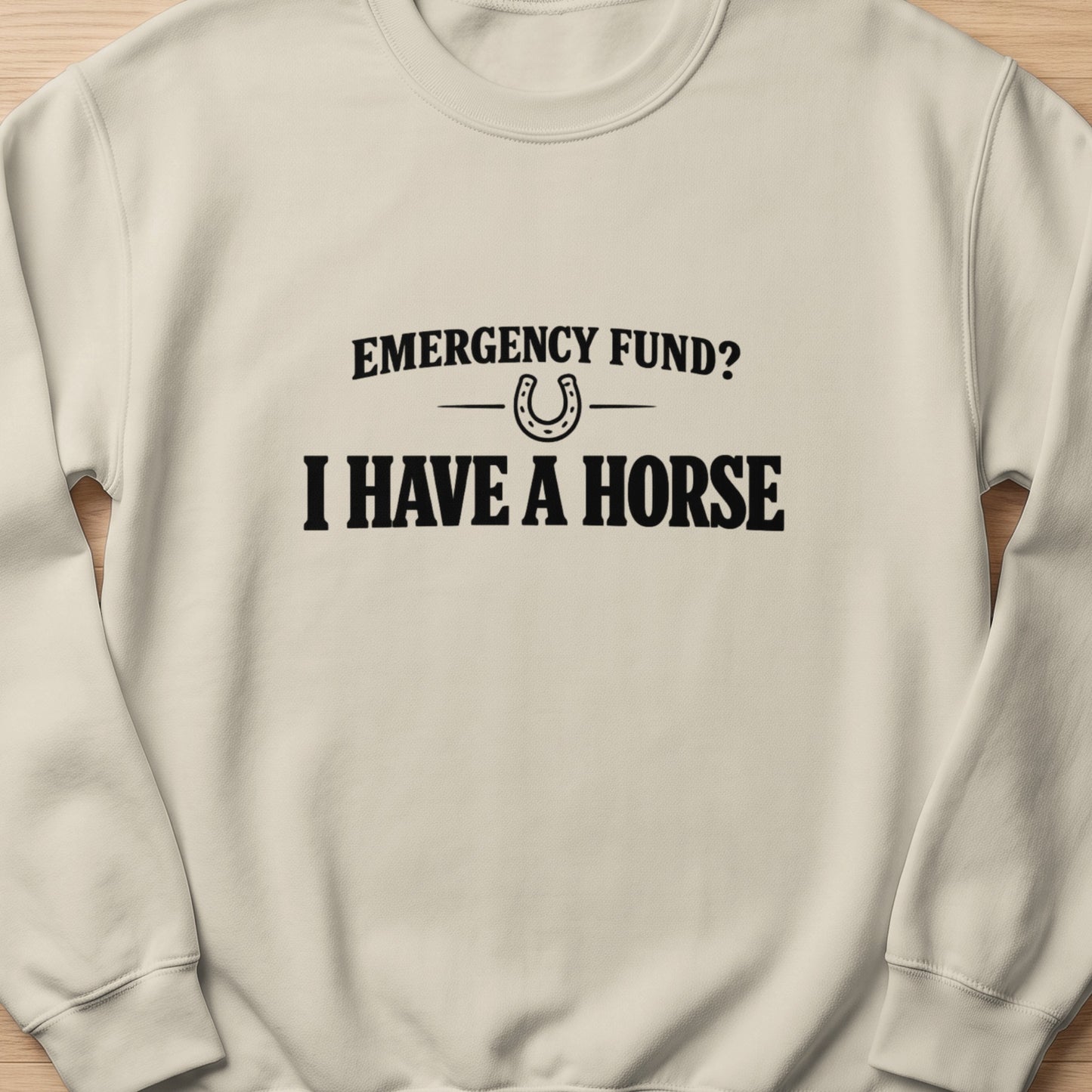 Cream sweatshirt with black text "Emergency Fund? I Have a Horse" and horseshoe graphic.