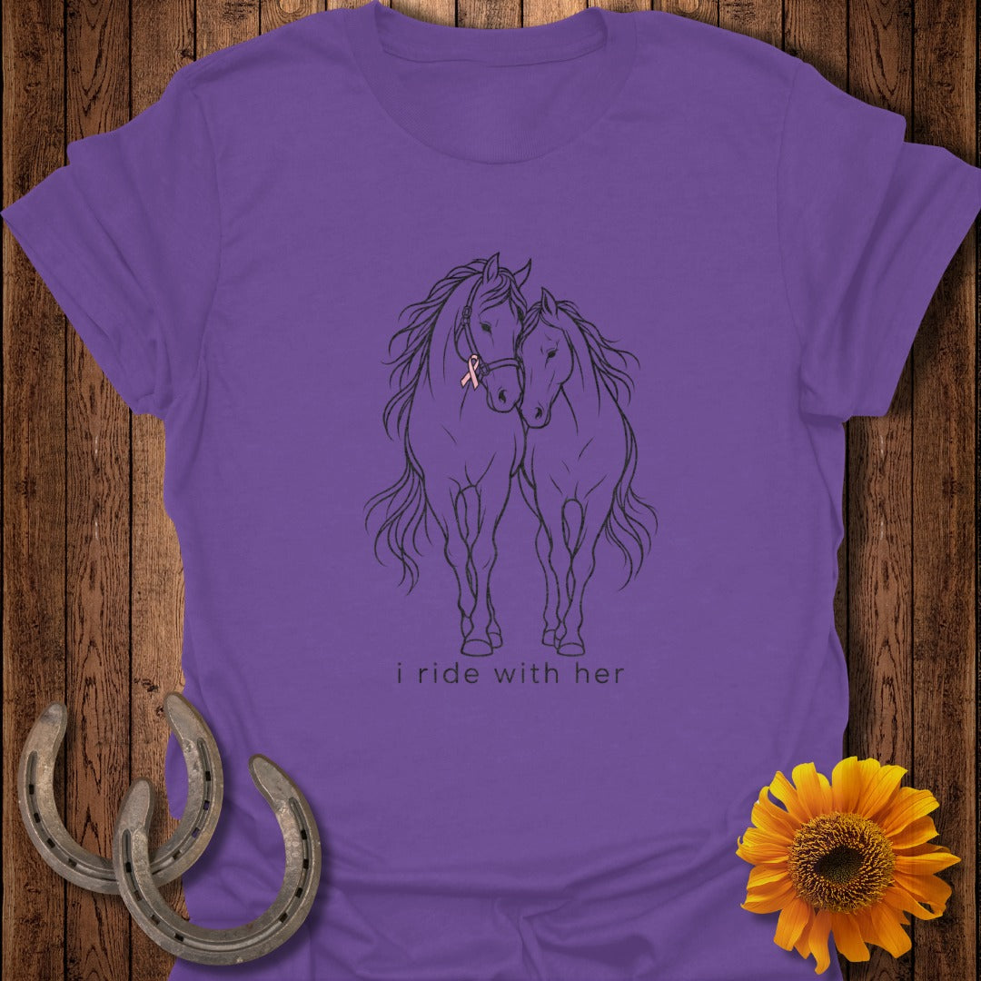 Purple t-shirt with line drawing of two horses, one with a pink ribbon, and text "i ride with her".
