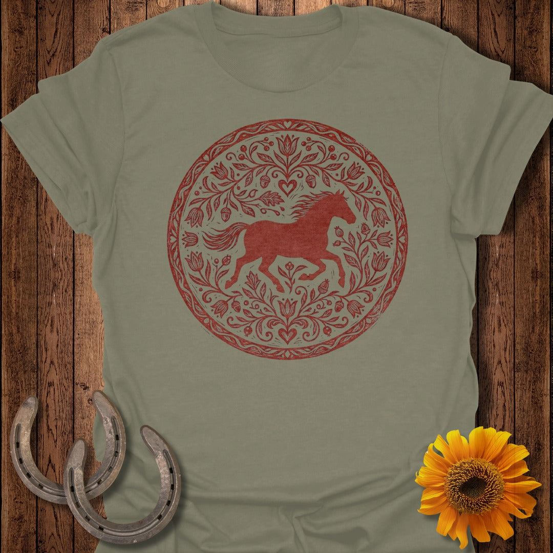 Green t-shirt with circular red horse and floral design, featuring horseshoes and sunflower.
