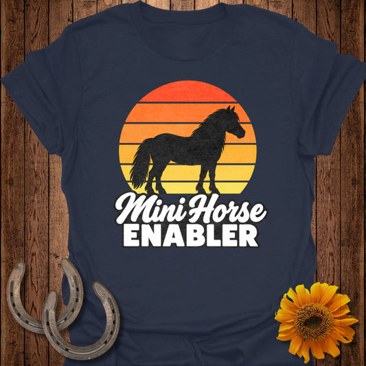 Dark blue t-shirt with silhouette of mini horse against a retro sunset and text "Mini Horse ENABLER."