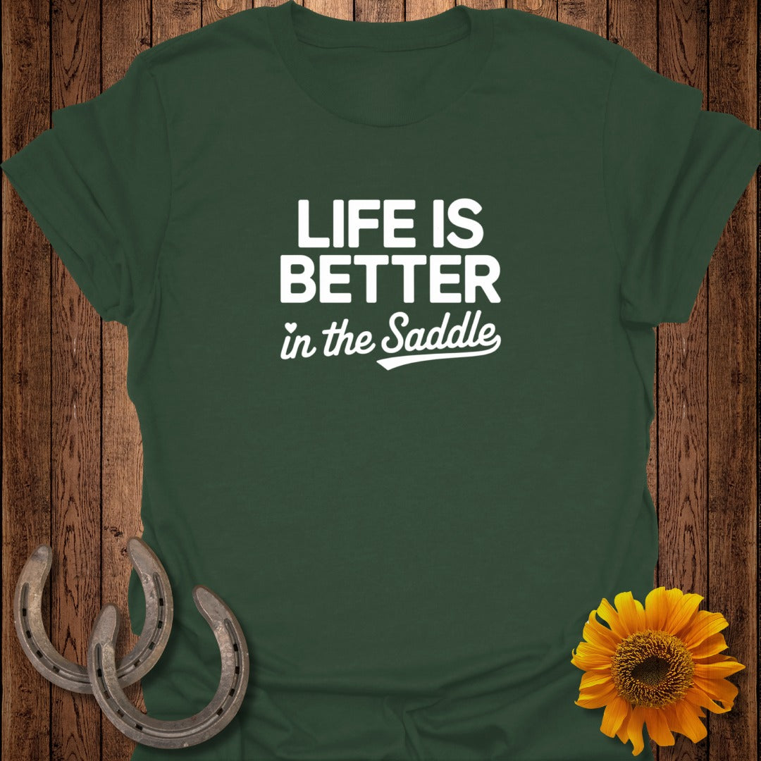 Green t-shirt with "Life is Better in the Saddle" text, two horseshoes, and a sunflower.