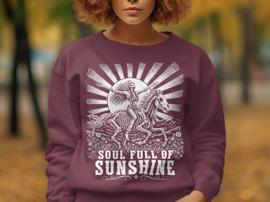 Maroon sweatshirt with skeleton on horse and text "Soul Full of Sunshine."