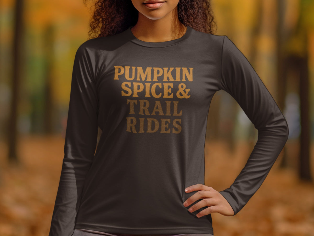 Long sleeve shirt with text "Pumpkin Spice & Trail Rides" in gold.