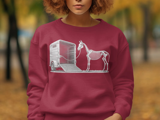 Horse skeleton being loaded into a trailer on a dark red sweatshirt.