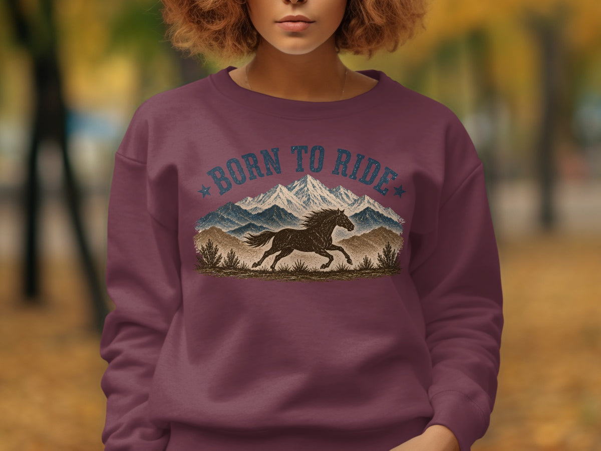 Burgundy sweatshirt with "Born to Ride" text and running horse over mountains.