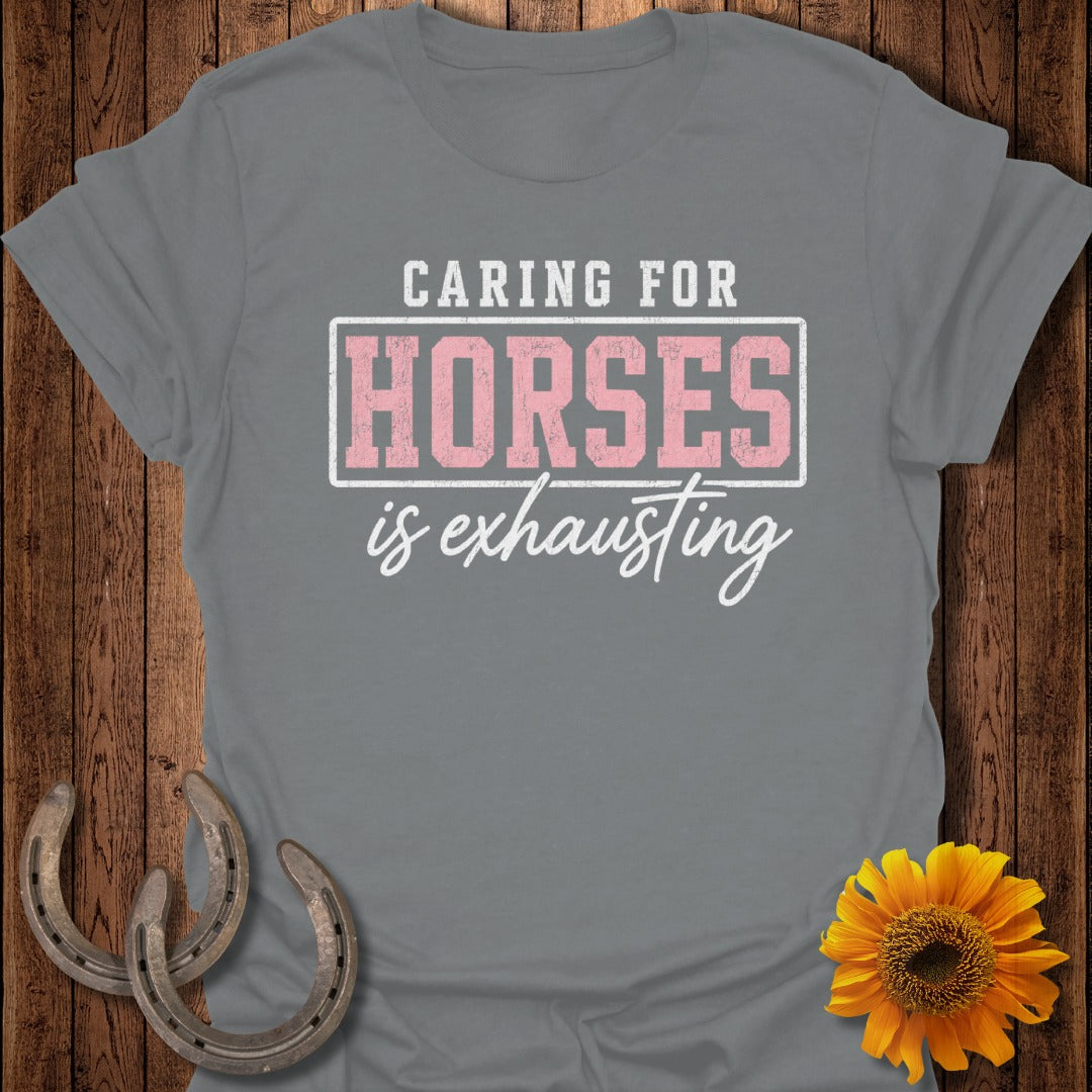 Gray t-shirt with "Caring for horses is exhausting" text and horse shoes.