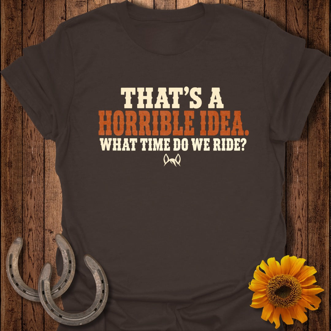 Brown t-shirt featuring the text "THAT'S A HORRIBLE IDEA. WHAT TIME DO WE RIDE?" in orange and cream.