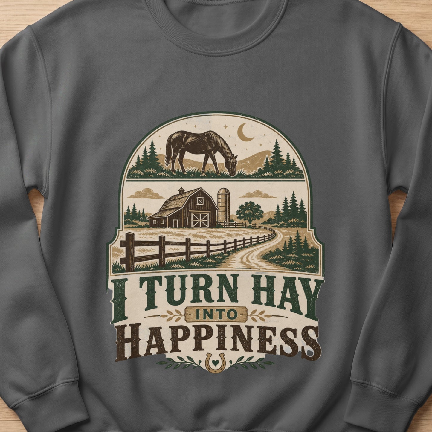 Graphic on sweatshirt with horse, barn, silo, fence, trees, and text "I TURN HAY INTO HAPPINESS".