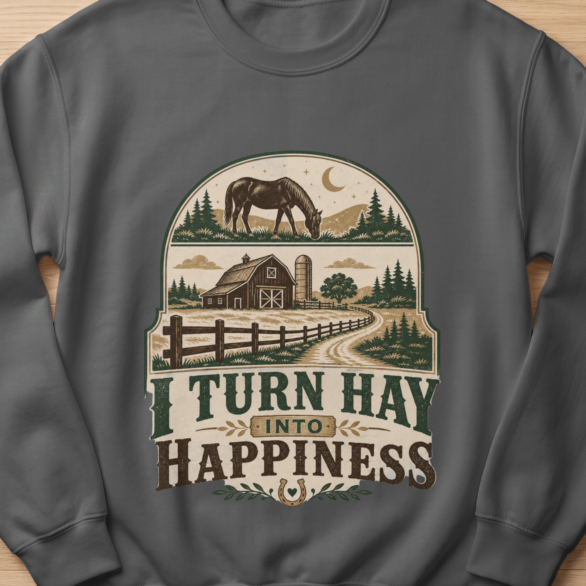 Graphic on sweatshirt with horse, barn, silo, fence, trees, and text "I TURN HAY INTO HAPPINESS".