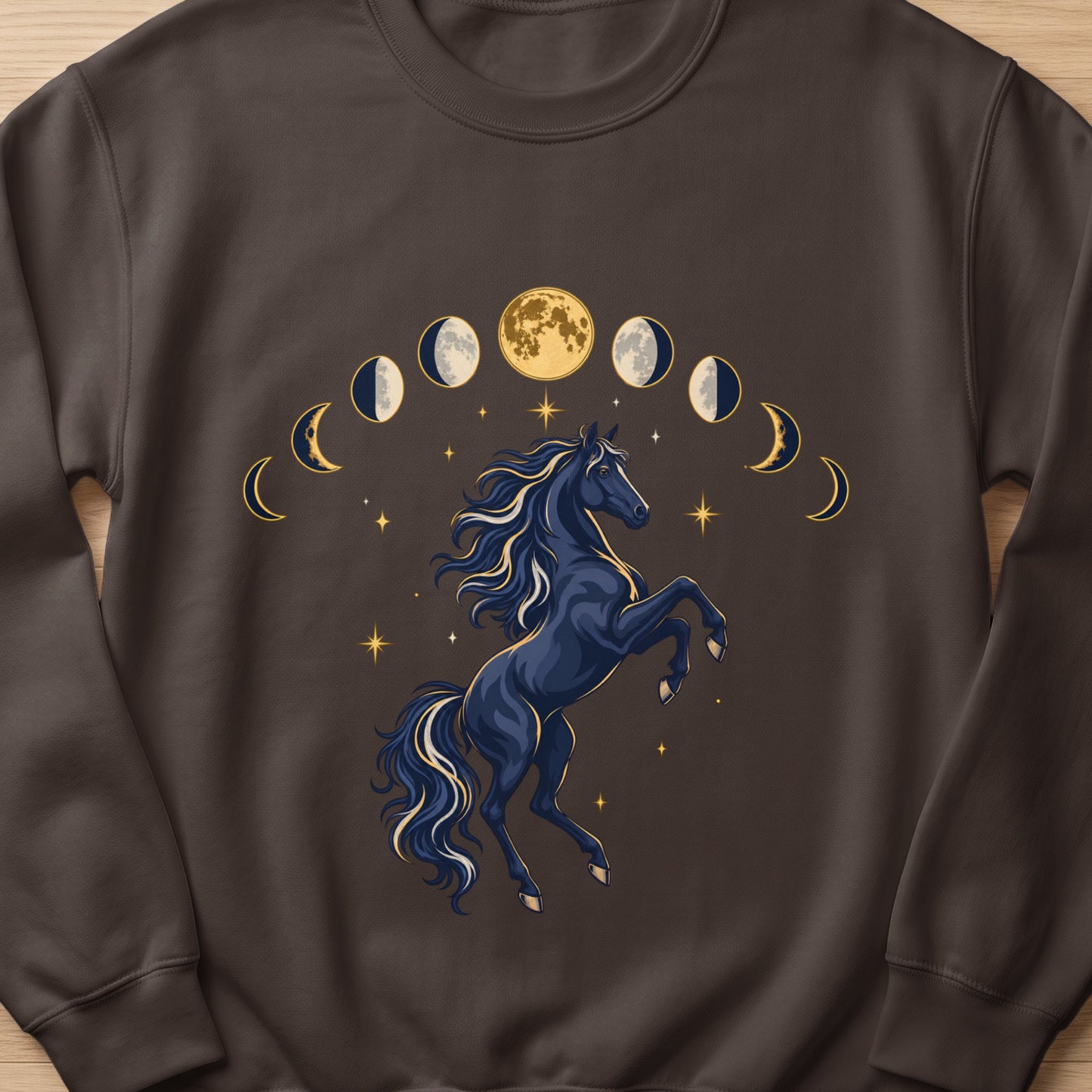 Dark blue horse rearing with moon phases and stars graphic on brown sweatshirt.