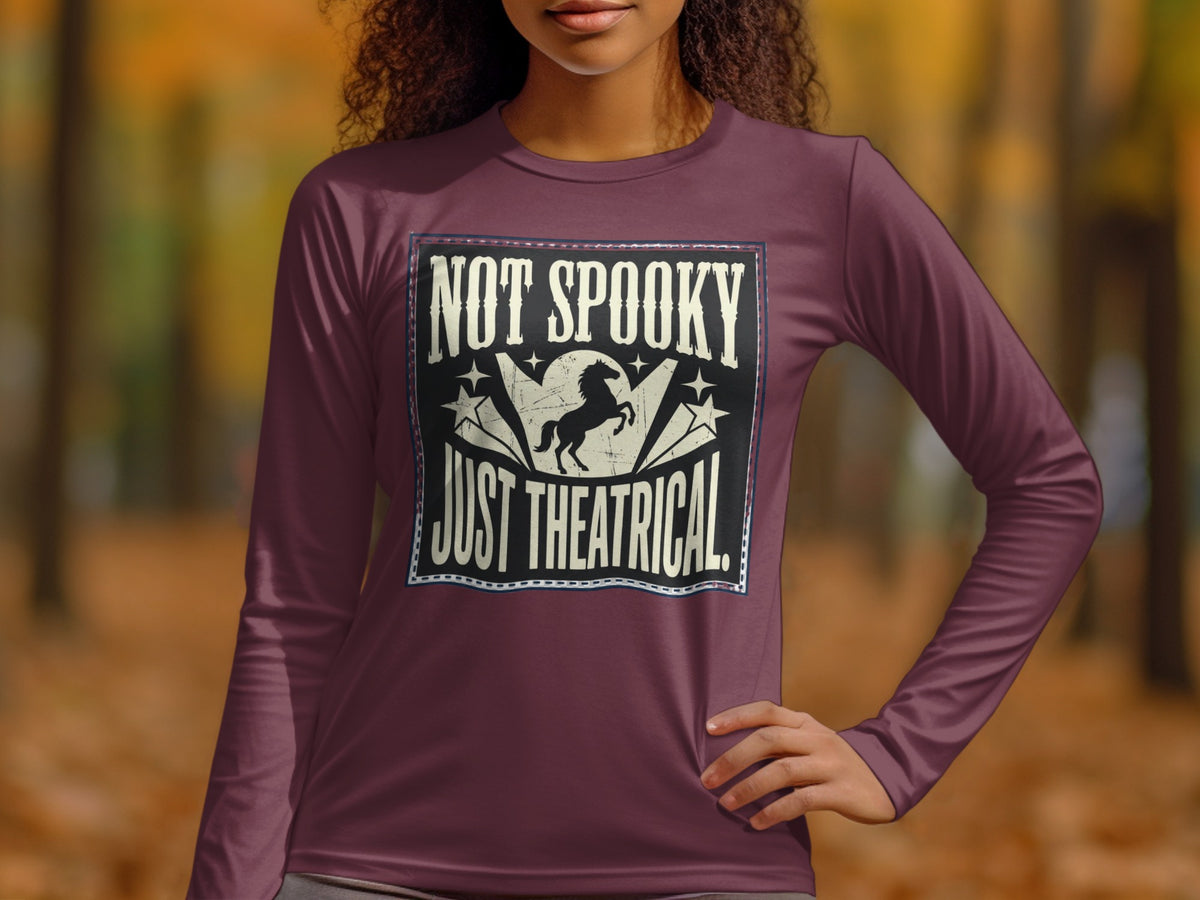 Long-sleeve shirt with "NOT SPOOKY JUST THEATRICAL" text and a horse graphic.