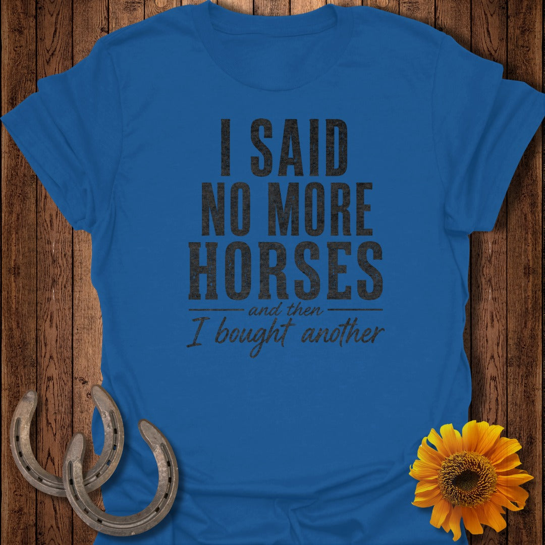 Blue t-shirt with black text "I said no more horses and then I bought another" and horse shoes.