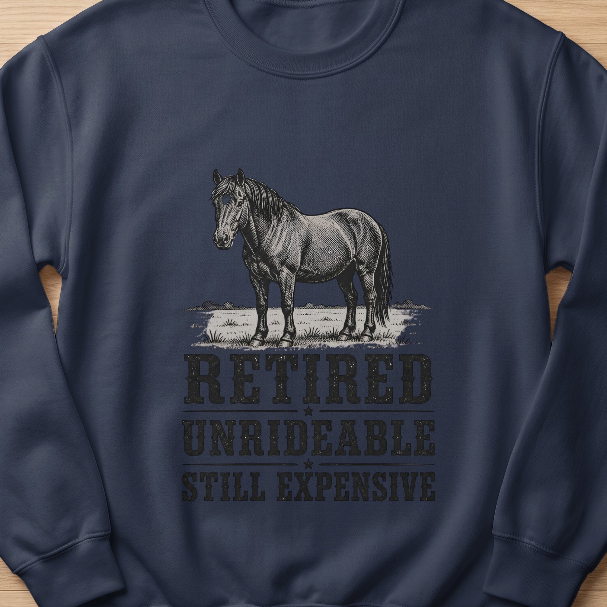 Navy sweatshirt with sketch of a horse and text "RETIRED UNRIDEABLE STILL EXPENSIVE"