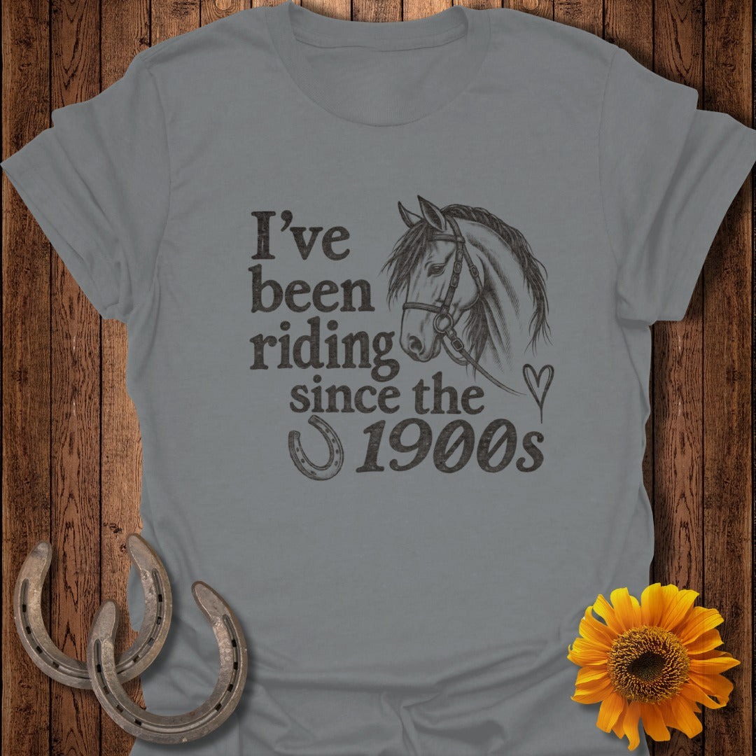 Grey t-shirt with horse illustration and text "I've been riding since the 1900s."