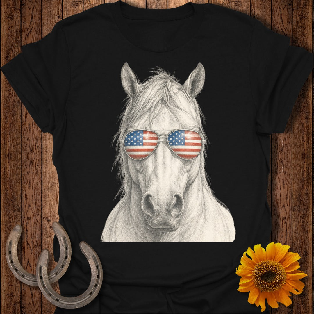 Horse wearing sunglasses with American flag lenses, next to horseshoes.