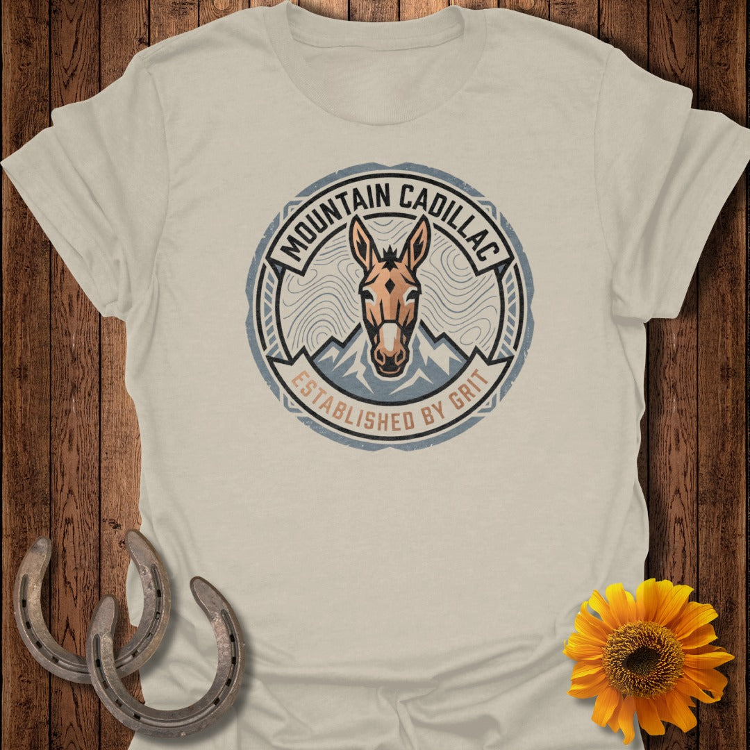 T-shirt with "Mountain Cadillac" logo, established by grit, and donkey illustration.