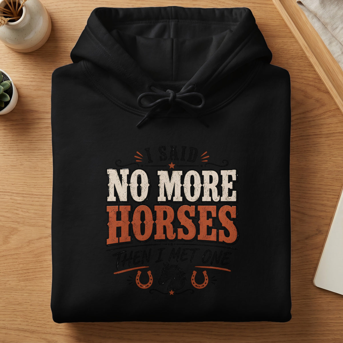 Black hoodie with text "I said NO MORE HORSES THEN I MET ONE" and horseshoe graphics.