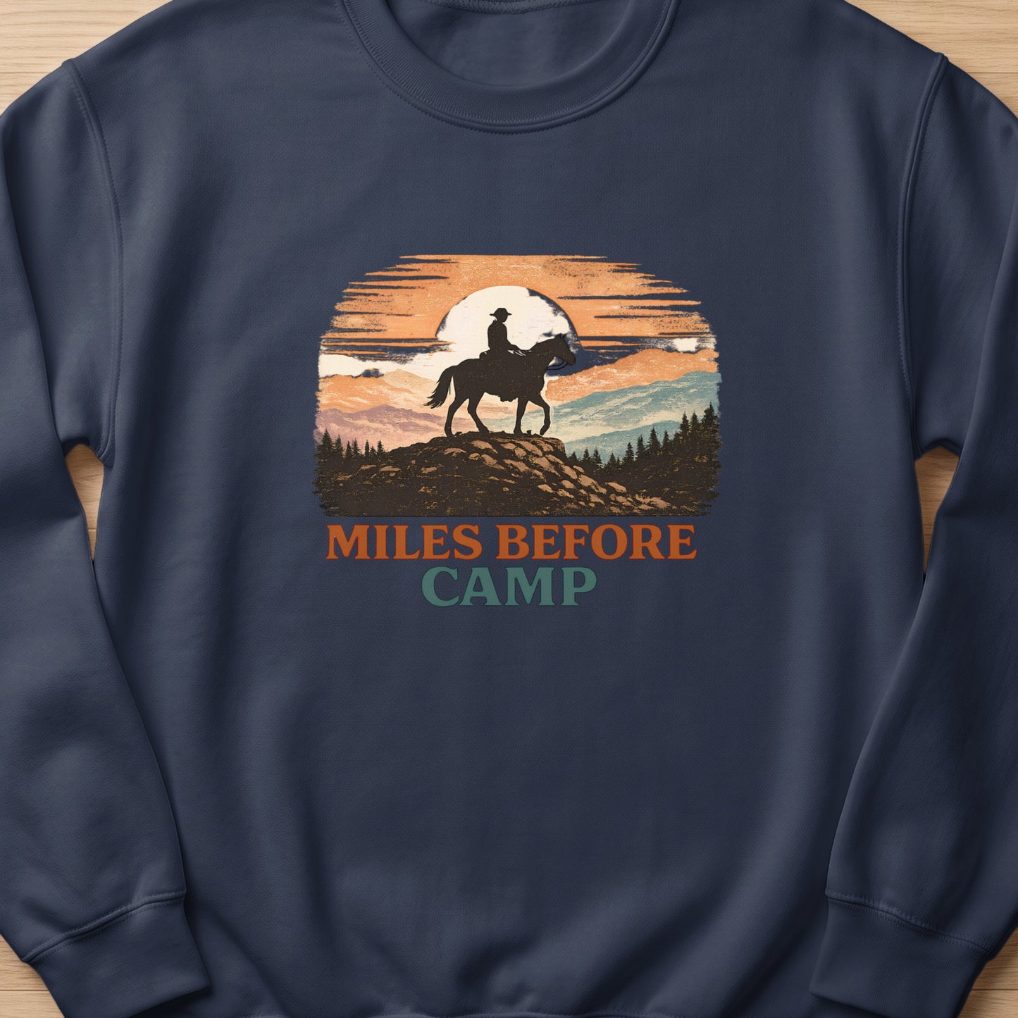 Silhouette of a rider on a horse against a sunset with text "MILES BEFORE CAMP".