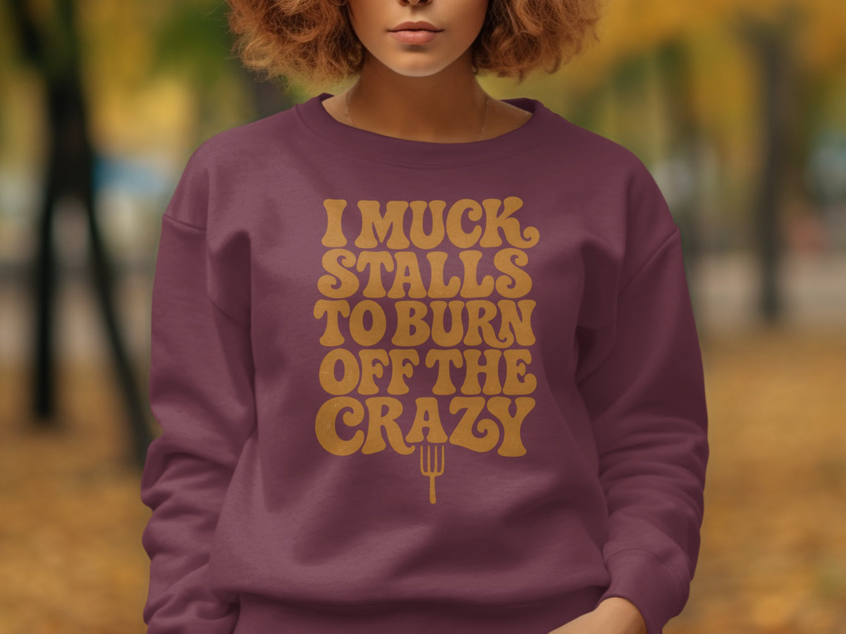 Maroon sweatshirt with "I Muck Stalls to Burn Off the Crazy" text and fork graphic.
