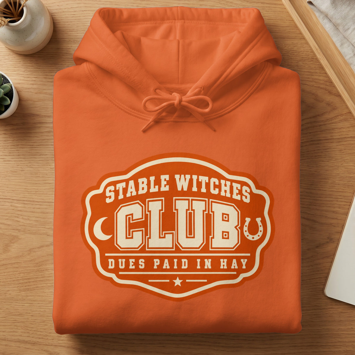Orange hoodie with "Stable Witches Club" and "Dues Paid In Hay" graphic.