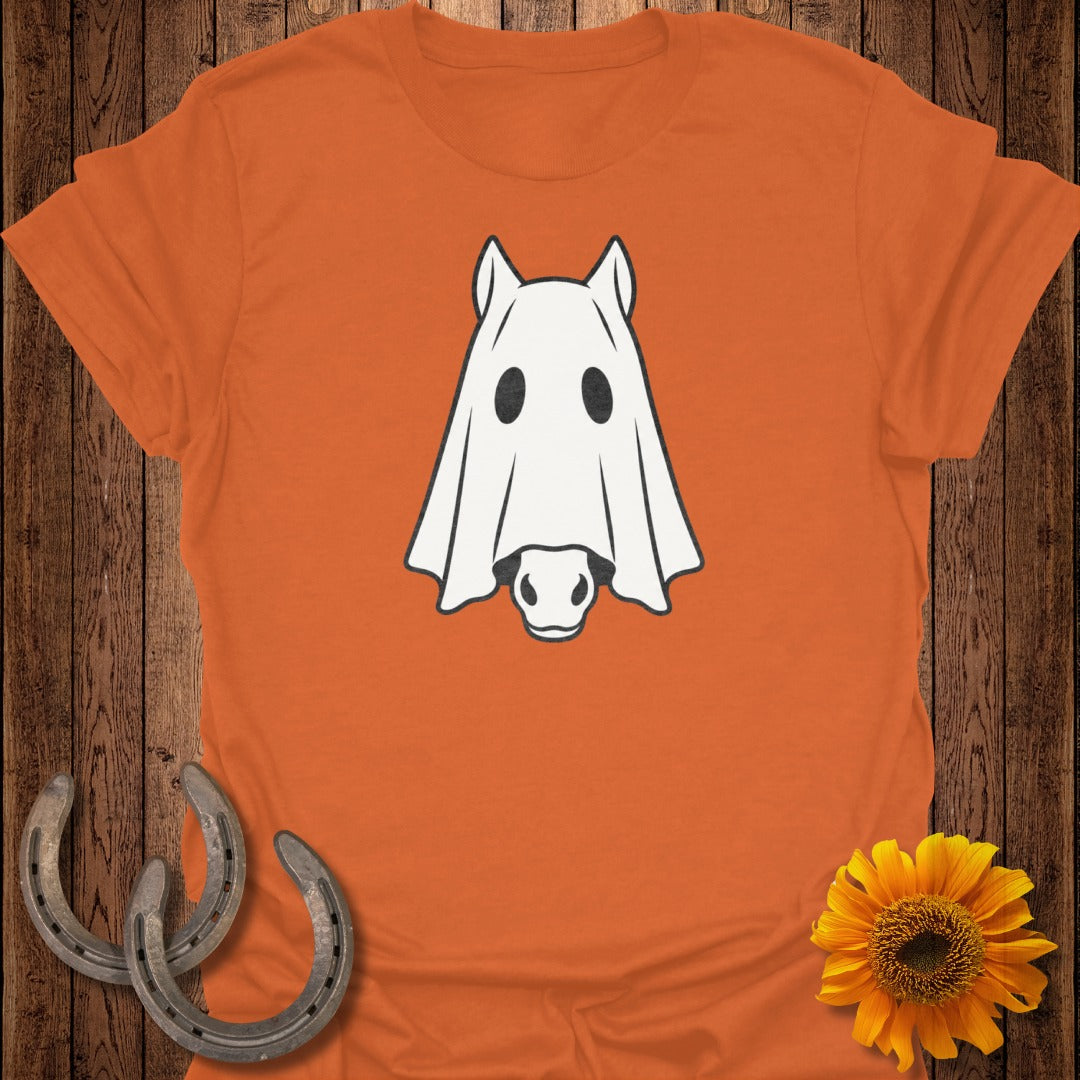 Orange t-shirt with a white ghost horse graphic, two horseshoes, and a sunflower.