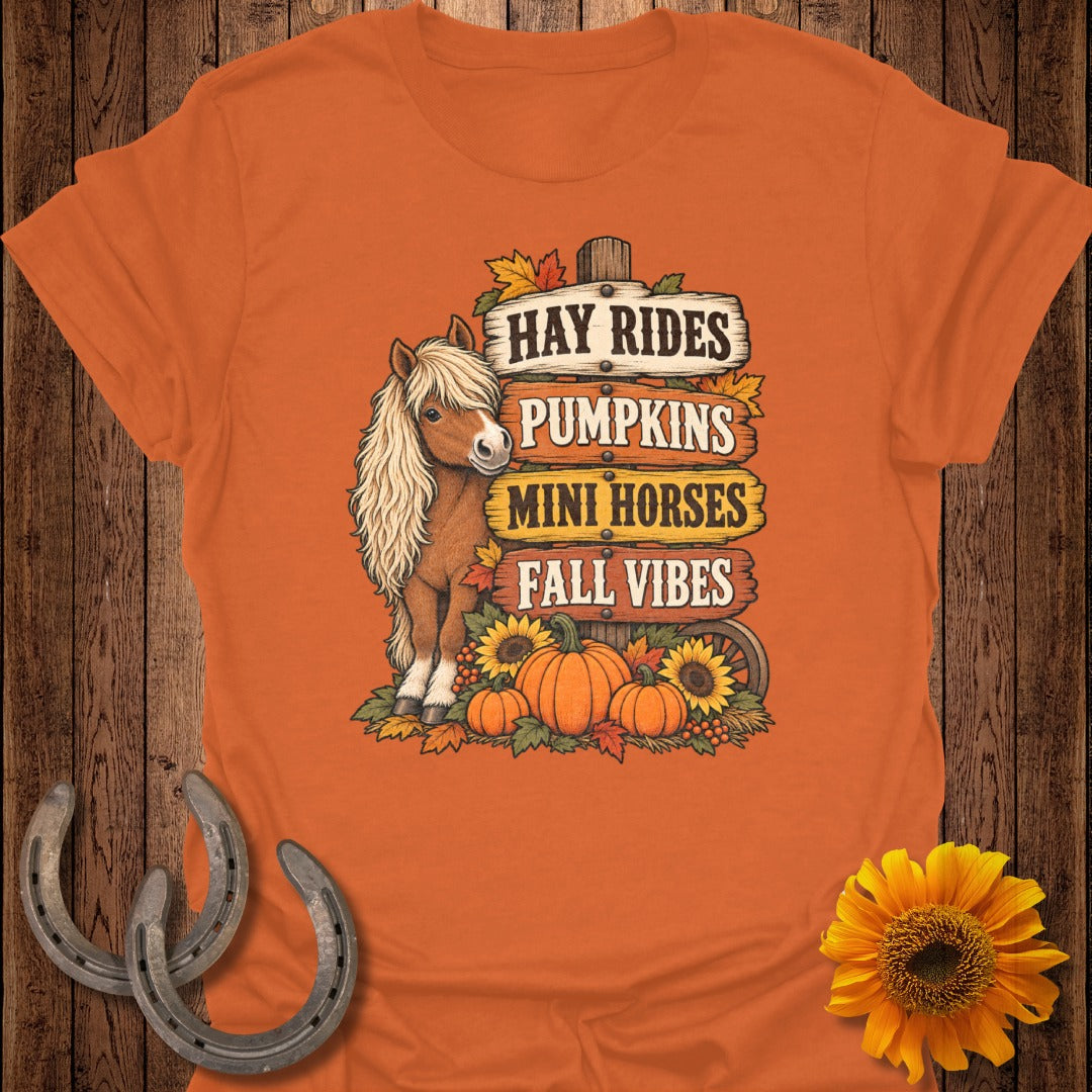Mini horse with sign reading "Hay Rides, Pumpkins, Mini Horses, Fall Vibes."