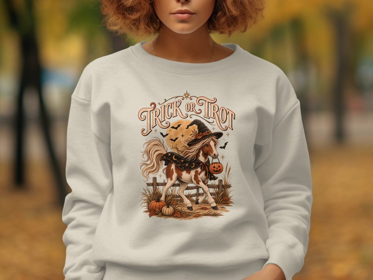 White sweatshirt with "Trick or Trot" and Halloween horse graphic.