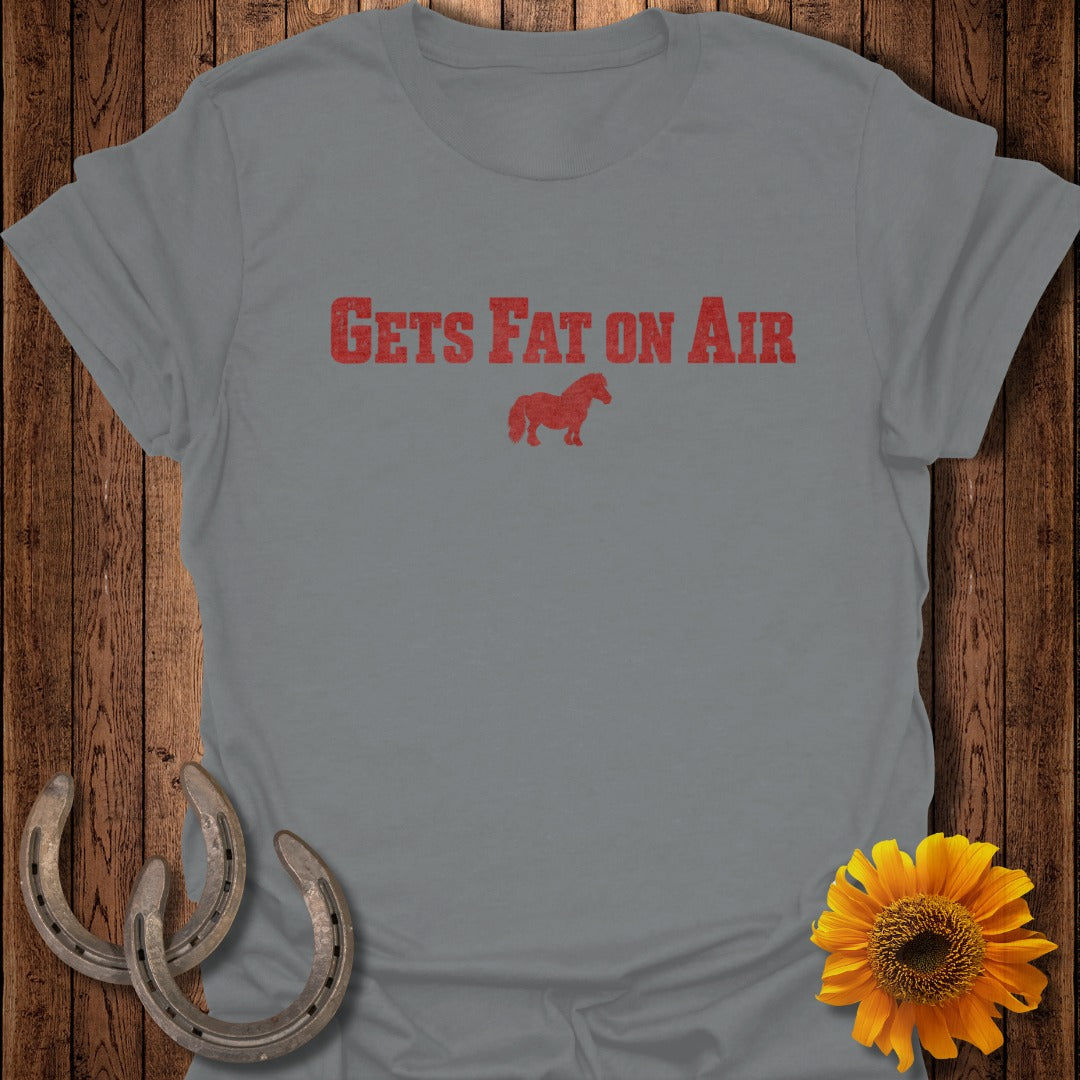 Gray t-shirt with red text "GETS FAT ON AIR" and a small horse graphic.