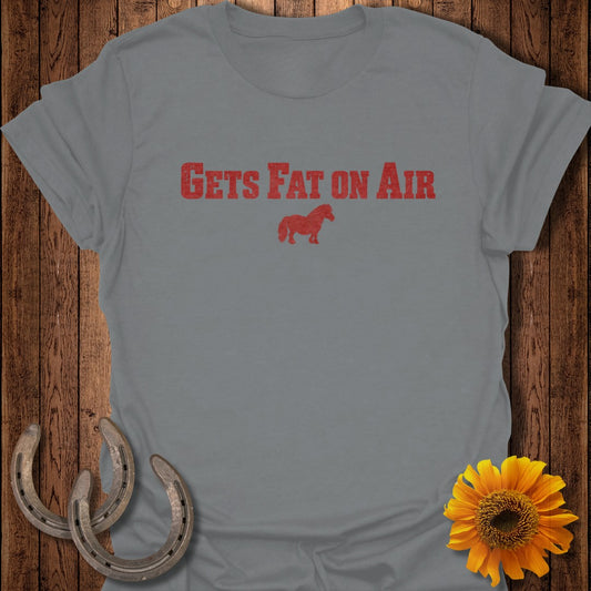 Gray t-shirt with red text "GETS FAT ON AIR" and a small horse graphic.