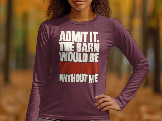 A person wearing a plum long-sleeve shirt with white text reading ADMIT IT. THE BARN WOULD BE BORING WITHOUT ME.