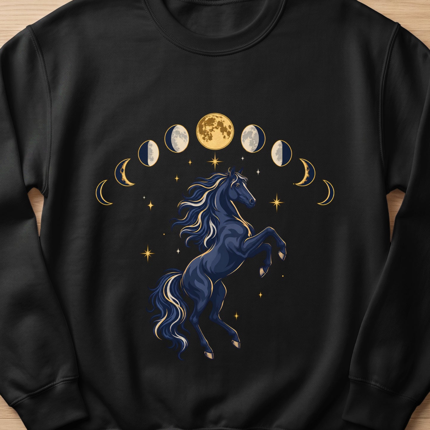 Dark blue horse rearing amidst moon phases and scattered stars graphic on black sweatshirt.
