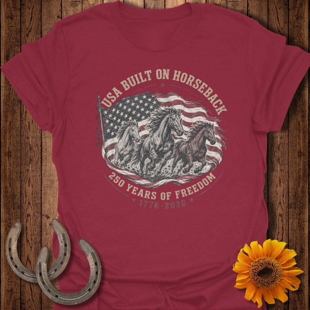 Red t-shirt with horses and American flag graphic reading "USA Built On Horseback 250 Years of Freedom 1776-2026".