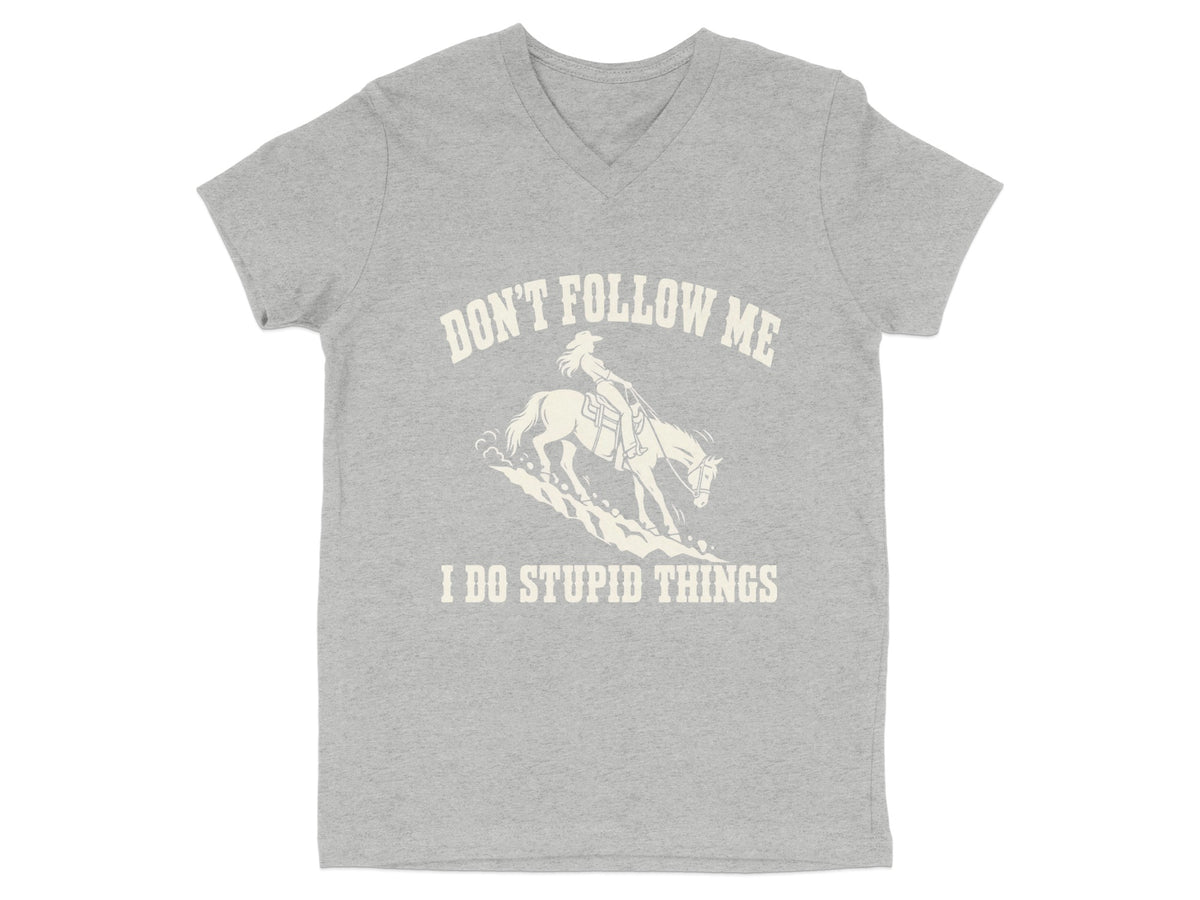 A grey V-neck t-shirt featuring a graphic of a cowgirl riding a horse and the text DON'T FOLLOW ME I DO STUPID THINGS.