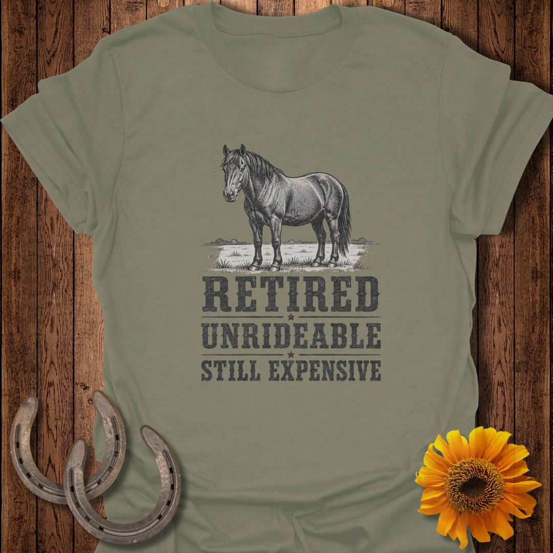 Olive green t-shirt with a drawing of a horse and text: "Retired Unrideable Still Expensive."