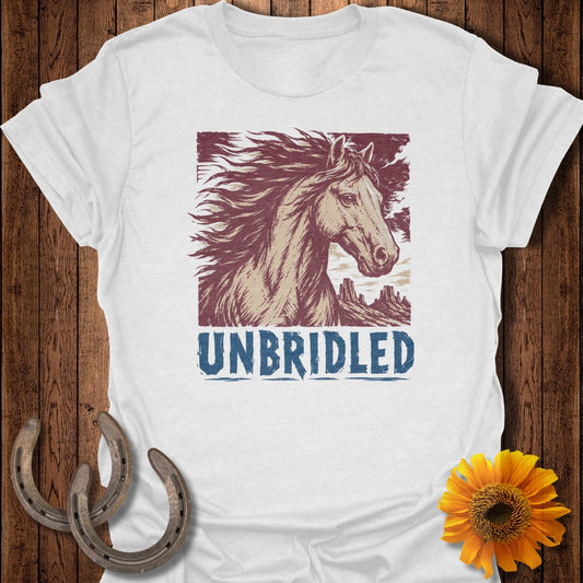 White t-shirt with distressed illustration of a horse and mountains, text "UNBRIDLED".