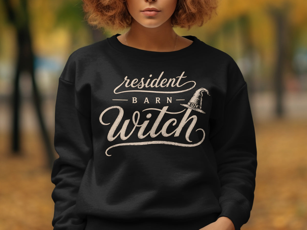 Black sweatshirt with cream text "resident Barn Witch" and witch hat graphic.