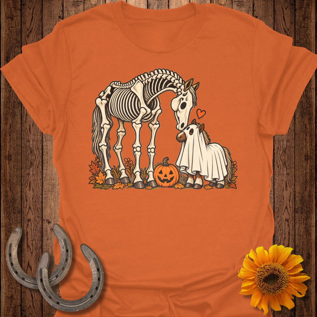 Skeleton horse and pony in ghost costume with pumpkin and autumn leaves.