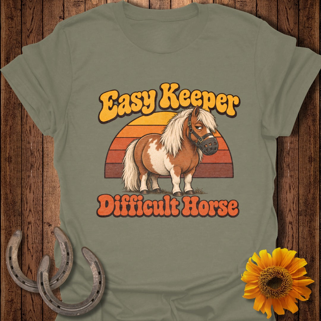 Brown and white pony with a muzzle, text "Easy Keeper Difficult Horse"